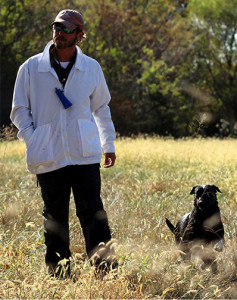 Trainer Chris Brinegar and Labrador retriever Zap, owned by Mike Olson of Cold Tree Kennels, look toward a judge following a successful run during the Kansas City Retriever Club’s field trial Saturday in Sedalia, Missouri. The three-day event consisted of Labrador, golden, and Chesapeake Bay retrievers competing to qualify for runs in amateur, open and derby.