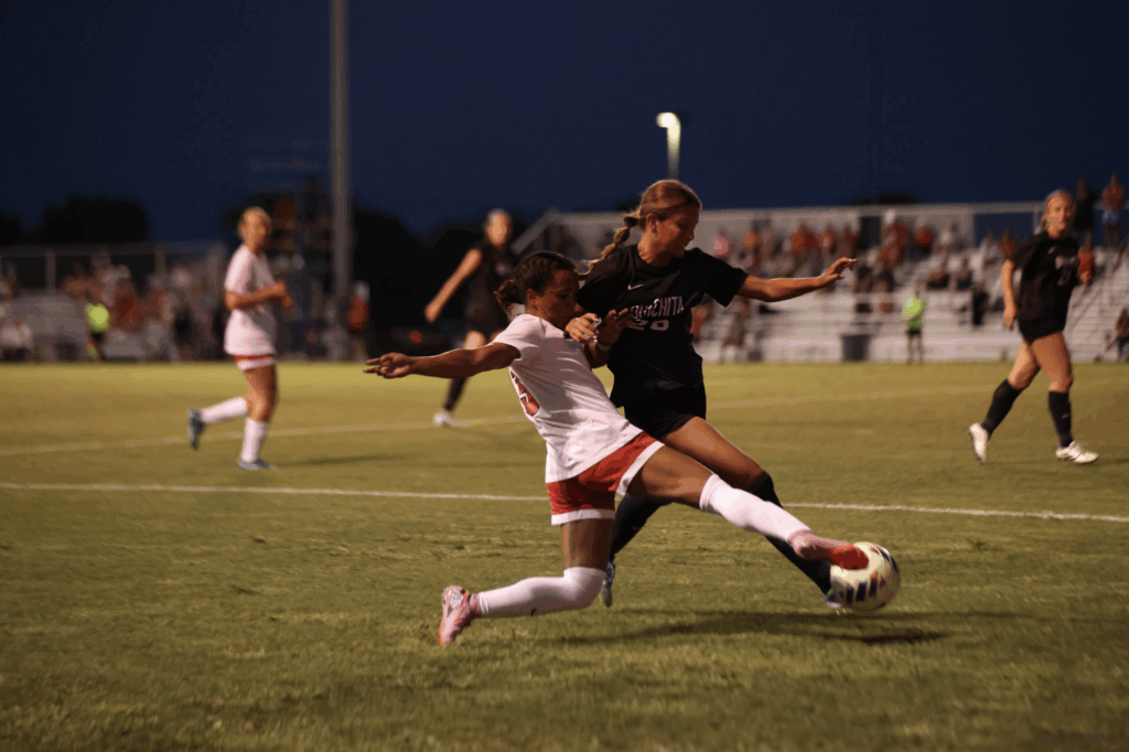 UCM Jennies defender Emilee Person tackles Ouachita Baptist defender Alexia Coca