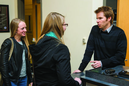Ashley Klaty (left), and Michelle Griffith (center) talk to Alex Buono after his presentation on Monday in Ward Edwards. (Photo by ANDREW MATHER, Photo Editor)