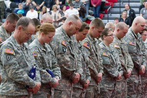 Sgt. 1st Class Barry Keck and Pvt. Haley Cronk hold the flags they received as the oldest and youngest members. (Photo by ANDREW MATHER)