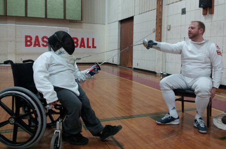 Eleven-year-old Wyatt Sigsbury (left) receives a fencing lesson from instructor Dusty Brooks (right). (Photo by ALEXANDRA LAMBDIN, for The Muleskinner)