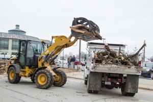 Heavy equipment is brought in to remove scattered debris.