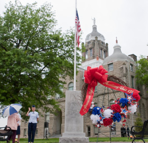 Members of the Warrensburg American Legion gather at the Johnson County Courthouse on Holden Street for a reading of the names of fallen soldiers from the stone marker. The ceremony was relocated to the American Legion building on Young Street due to inclement weather. 