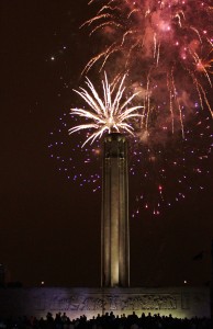 Spectators are silhouetted against the wall of the Liberty Memorial as they watch the fireworks burst behind the tower. 