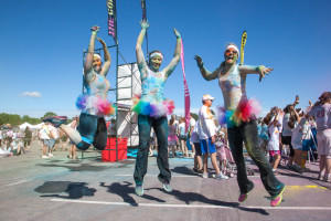 From left, color runners Liza Scharhag, a nanny from Olathe, Kan.; Missy Wilkinson Zadow, a polysomnographic technologist from Overland Park, Kan.; and Lara McCracken, a legal assistant from Kansas City, Mo., jump in celebration of a successful and fun time at The Color Run.