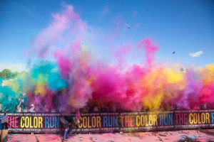 During the final color throw of the day, the air is filled with every color of the rainbow as hundreds of people throw fistfuls of color into the air. Color throws take place every 10 minutes at the color celebration at the end of the race.