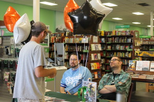 Nitz, seated left, and Smallwood, seated right, chat with a fan during a recent visit to Hastings in Warrensburg.