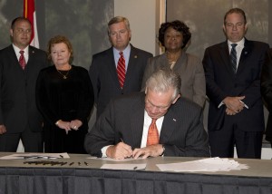 Photo by BRYAN TEBBENKAMP (UCM Photo Services) Missouri Gov. Jay Nixon signs Senate Bill 381 into law at UCM Thursday morning. The bill will help fund the Missouri Innovation Campus, which UCM sponsors.