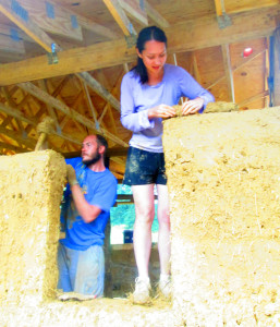 (Photo by Kelsey Harmon) Mike and Andrea Reinhardt work on the walls of their house. They hope to be able to move in by the end of fall.