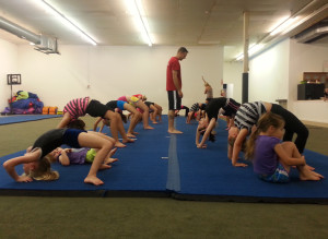 (Photo by Alexandra Lambdin, digitalBURG) Twister Sports co-owner Dustin Fritsch leads his students with warm-up stretches as class begins Tuesday evening.