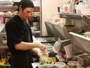 Photo by Kevin Lyon/digitalBURG Ian Zoellers prepares a kale salad at Cafe Blackadder.