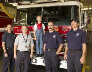 From Left: Captain Terry Hill, Fire and Emergency Prevention Officer Jeremy VanWey, Karsten Eckhoff, 6, and Firefighter Specialist JD Gudde, and Firefighter Specialist Doug Brookshier tour the firestation celebrating Eckhoff's 