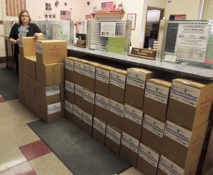 By MEGAN RYBA County Collector Ruthane Small stands by numerous boxes containing blank statements that she and her staff will use for printing Johnson County property tax bills.