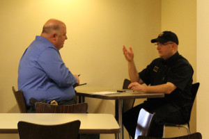 PHOTO BY LEAH WANKUM / MANAGING EDITOR Andy Lasater (right) gives his statement about the robbery to Detective Gary Schmidt with Public Safety Monday morning in Chick-fil-A.