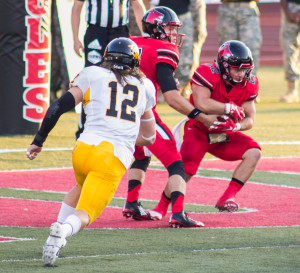 PHOTOS BY JERRY POESE / PHOTOGRAPHER Quarterback Garrett Fugate hands off to running back Evan Campbell early in the second quarter of the game against Missouri Western.