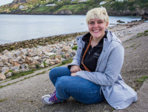 Megan Stanley sits by the shore in Howth, Ireland on a sunny day last summer. 