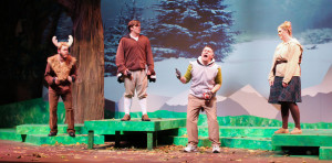 Mounty the Moose, played by Austin Hook (far left), Gustav, played by Zach Craft (second from left), and Maple Cheeks, played by Hannah Micaelree (far right), get a pep talk from Quarterback Aaron Rogers, played by Chris Scott (third from left).