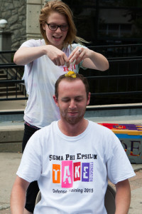 Meagan Fitzgerald, a junior dietetics major, cracks an egg on Nick Zahner’s head, all to raise money for a self-defense course.