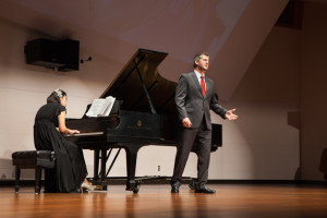 Singing tenor for “Lunge de lei . . . De’miei boleti spirit,” Jacob Sentgeorge's voice echoes and bounces off the walls. Miyeon Choi accompanies Sentgeorge on stage performing on the piano.