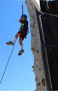 Warrensburg’s Keegan Young, 10, rappels down following a successful climb up the rock wall Saturday at this year’s Burg Fest in downtown Warrensburg.