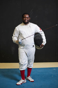 Eric Jefferson poses with his fencing gear Tuesday night.