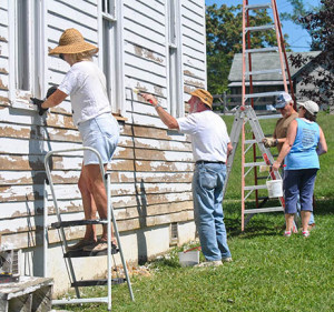 PHOTO SUBMITTED BY ERICA COLLINS Volunteers paint a local house during Project SERVE in October 2014.