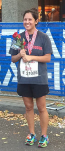 PHOTO SUBMITTED BY ANDREA LOPEZ / FEATURES EDITOR Andrea Lopez holds a rose after completing her first half-marathon a few weeks ago in her hometown Portland, Oregon.