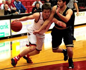 PHOTOS BY ALEX AGUEROS / SPORTS EDITOR Sophomore guard Spencer Reaves drives past a Concordia-St. Paul defender. Reaves finished with five points and had three of the team's 10 steals.