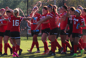 Senior forward Hannah Pyle, No. 16, douses her teammates with drinking water to celebrate the team's MIAA Tournament title.