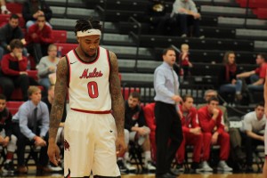 D'Marnier Cunningham, 0, looks down during a break in action against Fort Hays State University. The Mules lost to the Tigers 69-68. PHOTO BY ALEX AGUEROS