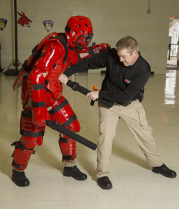 PHOTO SUBMITTED Recent Central Missouri Police Academy cadets Daniel Henry, left, and Jeremy Head demonstrate the RedMan suit.