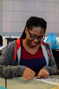 PHOTO BY MARIE NABORS / PHOTOGRAPHER Josephine Brooks, freshman illustration major, enjoys taking a crack at making a fan during the origami section of All Things Japanese event at the Union on Saturday.