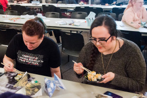 PHOTO BY MARIE NABORS / PHOTOGRAPHER Katie Oparnico (left), a senior ceramic studio art major, and Shannon Commerford, a freshman art education major, create a couple of colorful fish and enjoy some sushi.