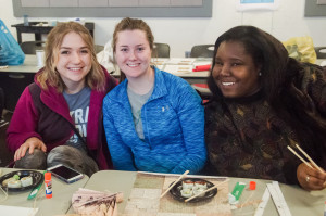 PHOTO BY MARIE NABORS / PHOTOGRAPHER From left, Lauren Koske,, a junior digital media production major, Chloe Albers, a senior elementary education major, and Danyale Fleming, a senior international studies major, pose with their origami creations and sushi Saturday in Union 236 for All Things Japanese, an event hosted by Spotlight.