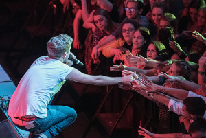 PHOTO BY MARIE NABORS / PHOTOGRAPHER Brian Dales, lead vocalist of The Summer Set, reaches out into the hands of adoring audience members.