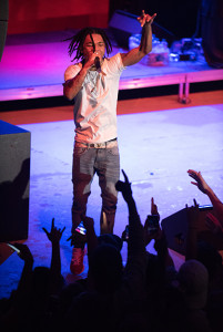 PHOTO BY MARIE NABORS / PHOTOGRAPHER Aaquil "Slim Jxmmi" Brown leads the crowd as they bounce in time to the music.