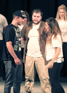 Joe Franzio (left) and Parker Wehking face off on either side of Jacob Clark, as Darth Vader and Princess Leia Organa, the iconic Star Wars characters.