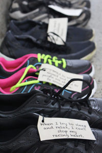 PHOTO BY ANDREA LOPEZ / MULTIMEDIA EDITOR A New Jersey based organization called Attitudes in Reverse presented an exhibit in the Student Recreation and Wellness Center Tuesday afternoon that featured 118 pairs of shoes. The number 118 represents the number of youth that died by suicide in Missouri last year.