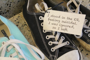 PHOTO BY ANDREA LOPEZ / MULTIMEDIA EDITOR A New Jersey based organization called Attitudes in Reverse presented an exhibit in the Student Recreation and Wellness Center Tuesday afternoon that featured 118 pairs of shoes. The number 118 represents the number of youth that died by suicide in Missouri last year.