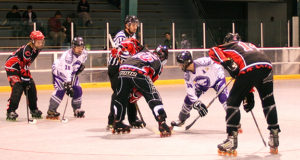 PHOTO SUBMITTED BY ANN RATLIFF In position to take the face-off, the UCM Roller Hockey team (in black uniforms) matched up against the Kansas State Wildcats on March 6 in the semi-finals of the Great Plaiins Collegiate Inline Hockey League playoffs.