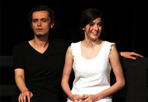 Steven Covert, playing the baby, sits next to a smiling Alice, played by Marisa Perry, during “Baby Talk” at the Department of Theatre and Dance’s One-Acts in Nickerson BlackBox. 