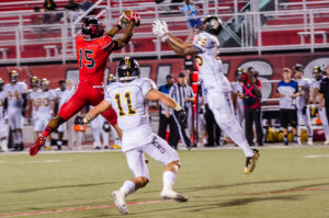 PHOTO BY MARIE NABORS/PHOTO EDITOR Wide receiver Wesley Thomas jumps over Fort Hays State defensive players to make a catch during the Mules 34-17 victory at home.